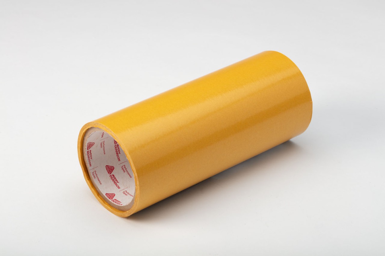 Roll of yellow pressure-sensitive adhesive tape from Avery Dennison Performance Tapes.