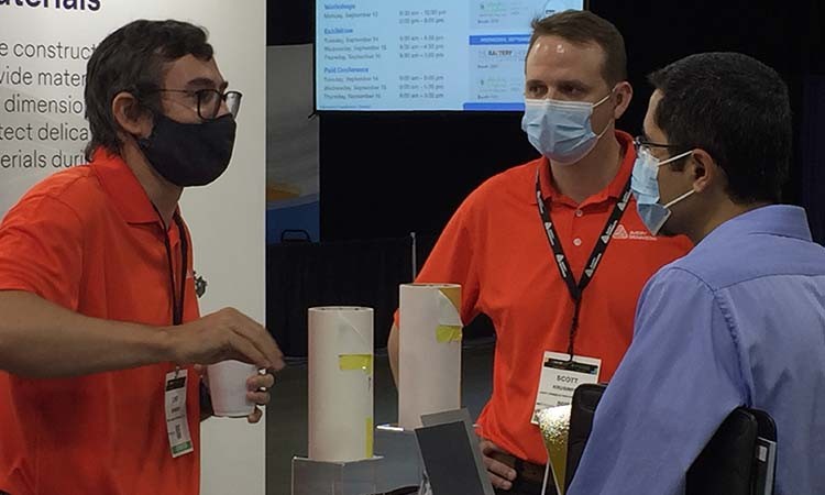 Photo showing Avery Dennison's Luke Johnson and Scott Krusinski speaking with attendees at the 2021 Battery Show in Novi, Michigan.