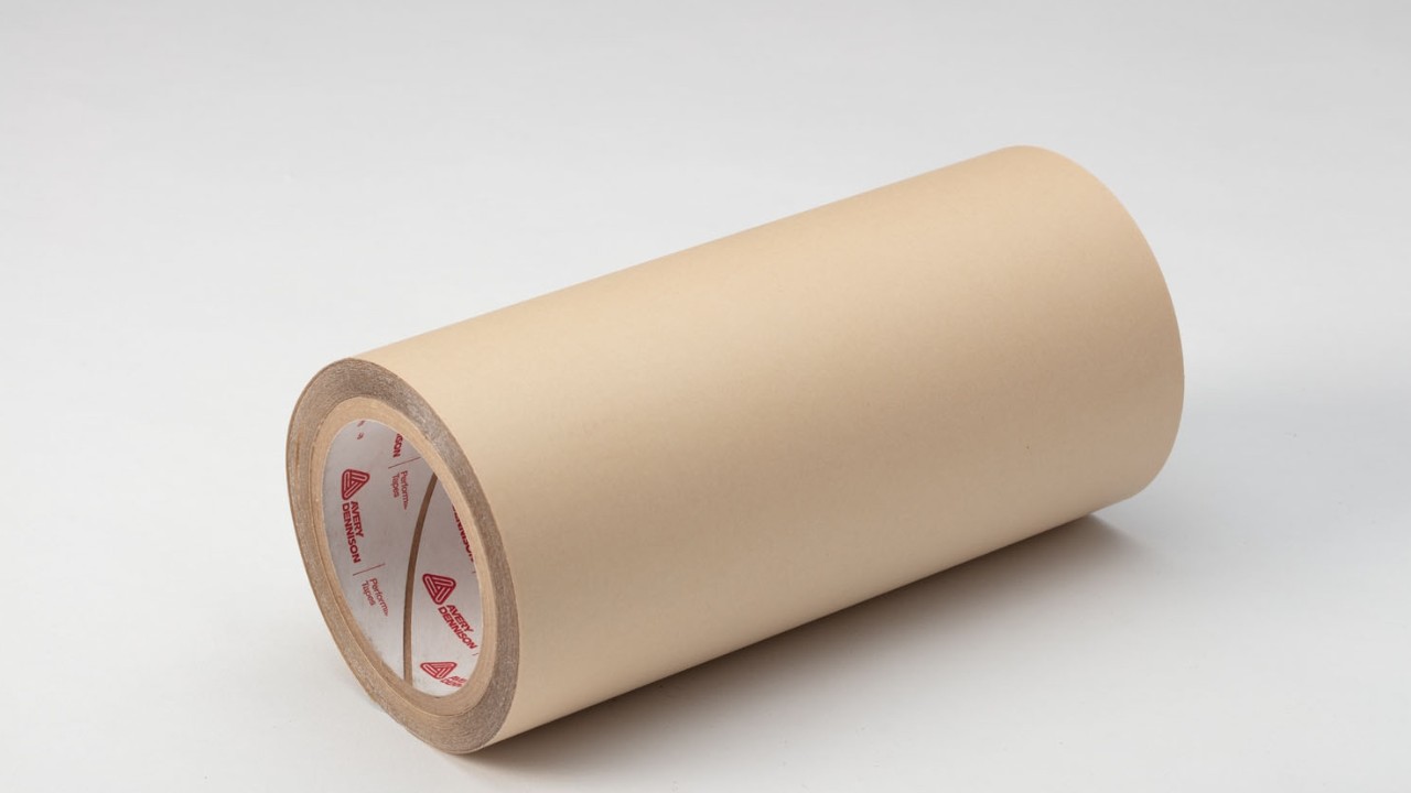 Photo of a roll of lamination adhesive. We offer pressure-sensitive lamination adhesives for a variety of durable label applications.